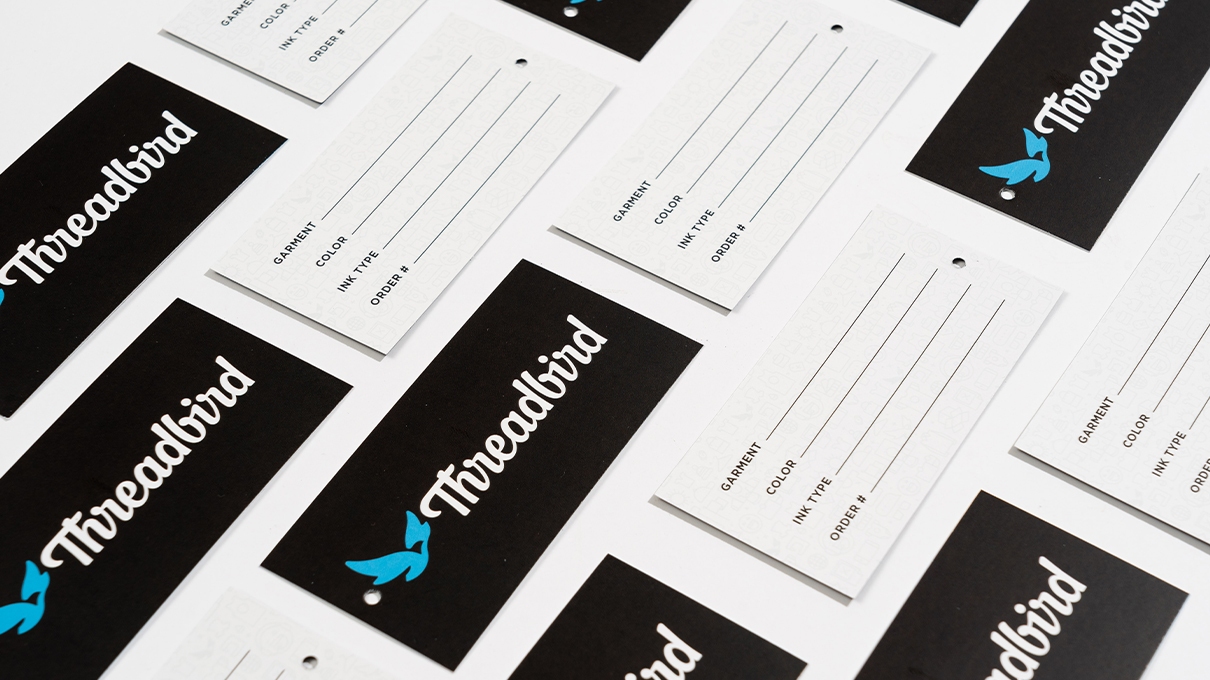 Flat lay of Threadbird branded hang tags